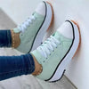 Top-down view of canvas low-top sneakers showing lace-up design