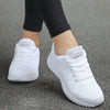 White lace-up sports sneakers with rainbow accents for active women