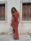 Sophisticated maxi dress featuring halter neckline, slimming ruching, and asymmetric design