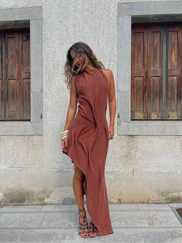 Sophisticated maxi dress featuring halter neckline, slimming ruching, and asymmetric design