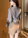 Chic striped blouse for office elegance, featuring a turn-down collar and single-breasted closure, perfect for professional w