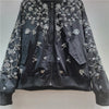 Textured embroidery and sequin pattern creating dimensional design on jacket