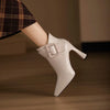Side view of pointed toe pumps featuring decorative belt buckle accent on vamp