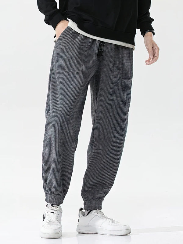 Side view of fleece-lined corduroy joggers showing relaxed fit and ankle cut