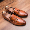 Charismatic tassel loafers in sleek black faux leather with a stylish design.