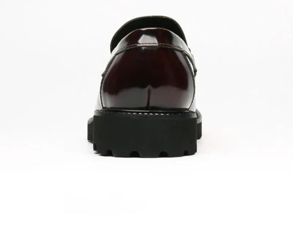 Black Oxfords in a shoe box, highlighting luxury office shoes.