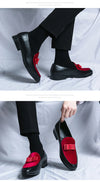 Men's black leather loafers styled for evening gala or formal event