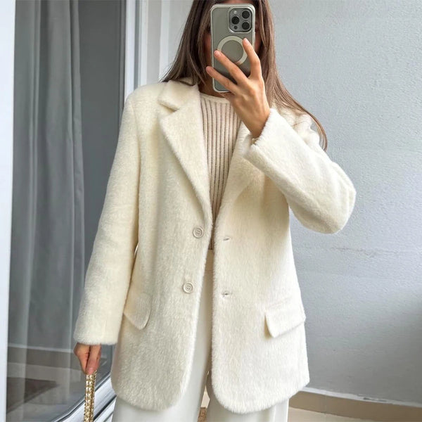 Flat lay of creamy white mohair blazer showing full design and classic tailoring details