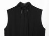 Close-up of ribbon detail on sleeveless black pleated top
