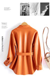 Chic women's sheepskin leather jacket with turn-down collar, lace-up belt, and adjustable waist for a stylish fit.