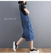 Detail shot of functional side pockets on baggy denim suspender jumpsuit for hands-free convenience
