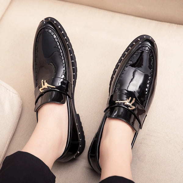 Close-up of pointed toe design on men's patent leather Oxford shoes.