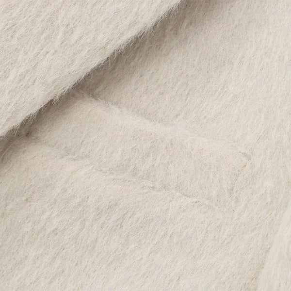 Creamy white mohair blazer texture detail highlighting plush polyester blend fabric
