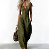 Woman wearing light blue denim V-neck wide leg jumpsuit with button-front detail