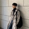 Men's long double-breasted trench coat in solid color with turn-down collar, perfect for autumn and winter streetwear.