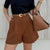 Belted high-waist shorts with regular fit and stretch fabric, ideal for versatile everyday wear from casual to polished