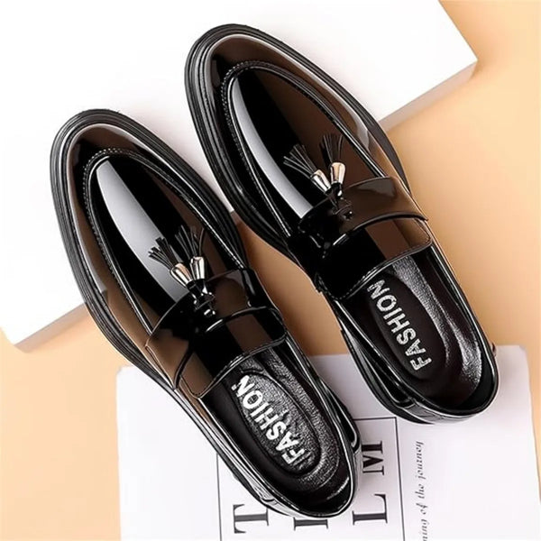 Classic black loafers featuring high-shine finish, slip-on design, and refined tassel embellishment for men