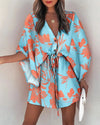 Full length view of above-knee floral dress with whimsical irregular ruffle hem