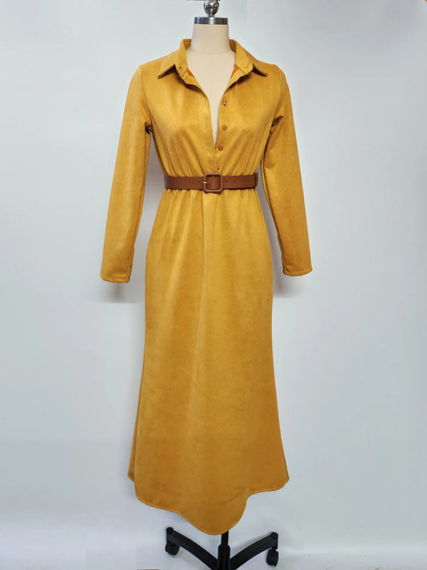 Flat lay of the Autumn Whispers suede dress with autumn leaves, showcasing its seasonal appeal.