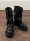 Chic women's mid-calf biker boots with buckle detail, zipper closure, and plush lining for comfort and style in winter.