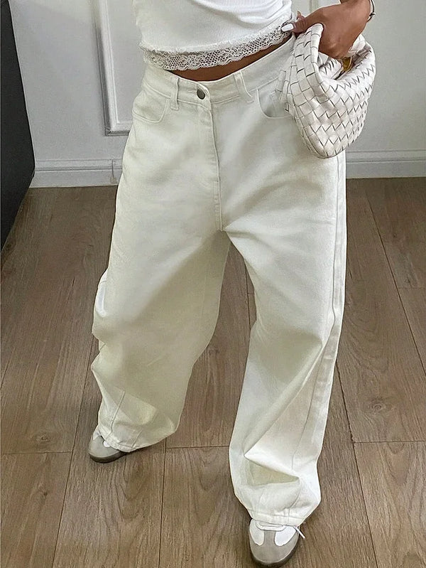 Women's white wide leg jeans featuring high waisted design and button pocket details