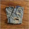Rebel Spirit Distressed Jeans in natural light, highlighting the rugged texture and color.