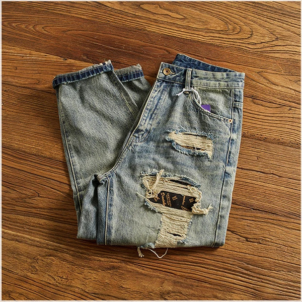 Rebel Spirit Distressed Jeans in natural light, highlighting the rugged texture and color.