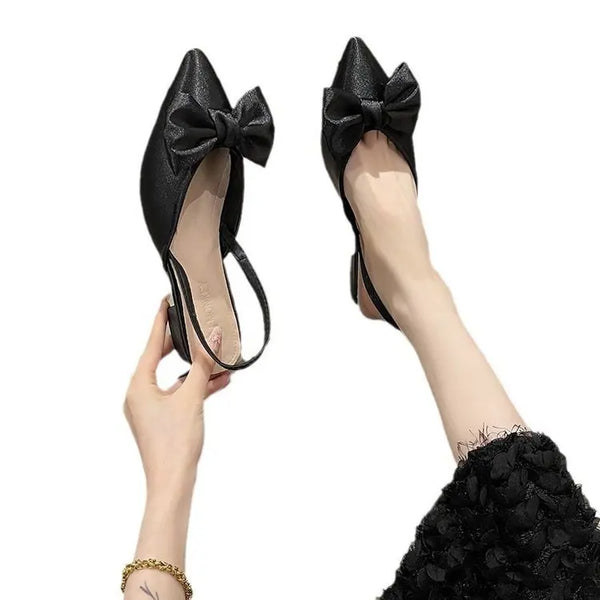 Casual-to-formal pointed sandals featuring soft sole and delicate butterfly knot