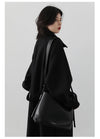 Sophisticated belted outerwear featuring turtleneck and streamlined silhouette
