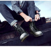 Close-up of the sleek design of black leather motorcycle boots.