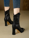 Contemporary black ankle boots featuring glossy patent leather and block heel