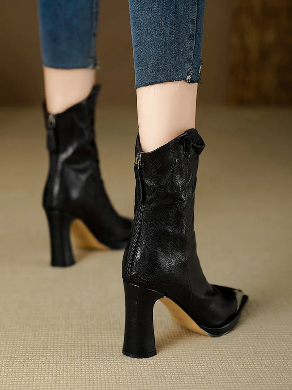 Contemporary black ankle boots featuring glossy patent leather and block heel