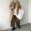 Chic Japanese vintage trench coat for men in black, featuring a single-breasted closure and stylish turn-down collar.
