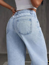 Chic wide-leg denim jeans for women, featuring a button-fly closure and light distressing for stylish everyday wear.