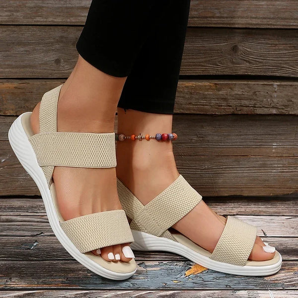 Low wedge sandals featuring breathable elastic knit upper and cushioned insole for all-day wear