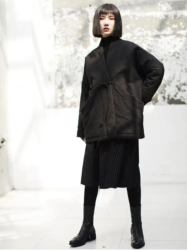 Beige oversized hooded jacket with belt detail and relaxed fit for layering over sweaters