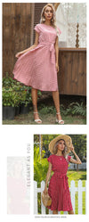 Front view of polka dot pleated dress with defined waistline