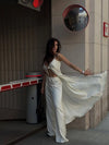Elegant white satin set featuring high-waist bottoms and loose-fit button-front top