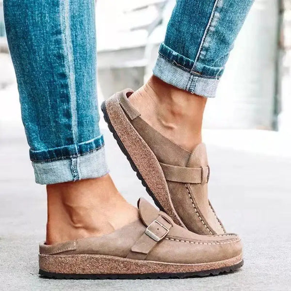 Flat buckle mules with elegant shallow silhouette and secure back strap for stable all-day wear