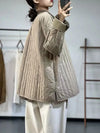 Khaki quilted jacket layered over sweater demonstrating versatile fall styling options