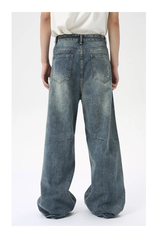 Men's washed blue wide leg jeans with structured yet relaxed aesthetic