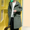 Stylish men's mid-length trench coat with hood, big pockets, and windproof features for autumn and spring outdoor wear.