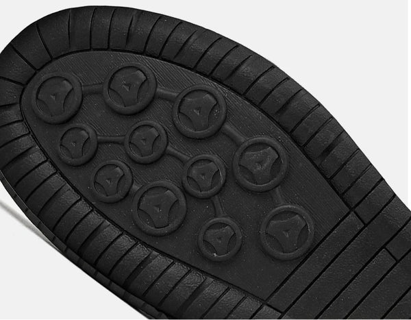 Close-up of rubber outsole tread pattern on leather loafer providing weather-ready grip and long-lasting durability