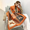 Cozy Cashmere Embrace scarf in soft beige with horse print design.