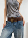 Vintage wide belt for women in black faux leather with metal buckle, perfect for casual or formal wear. Stylish accessory.