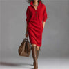 Model wearing the Fireside Chic dress by a crackling fire, showcasing its elegant style.