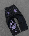 Artistic blue jeans with bold embroidery for a standout style.
