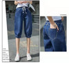 High-waist loose-fit harem jeans with modern calf-length design and pockets
