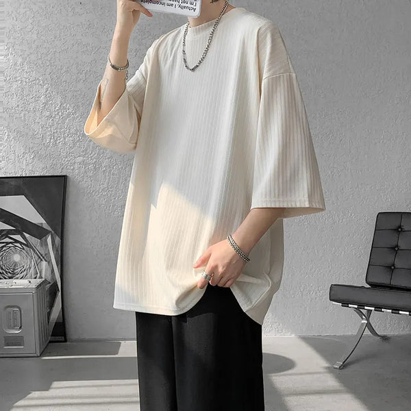 Unisex striped summer tee styled with a skirt, showcasing its versatility.