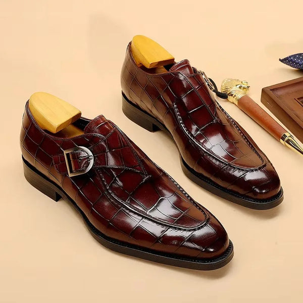 Dapper carved Oxford shoes in rich leather with detailed craftsmanship.